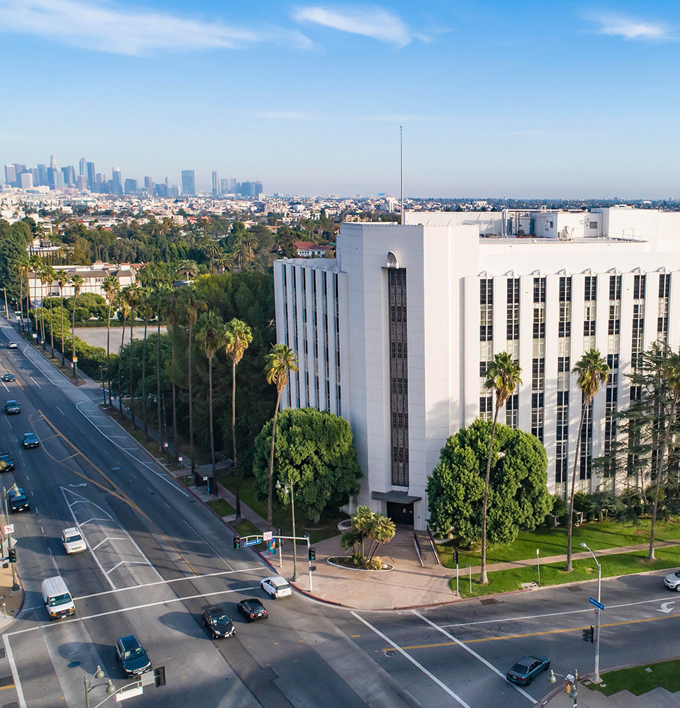 Aerial view of Wilshire Mullen with Los Angeles downtown skyline in background